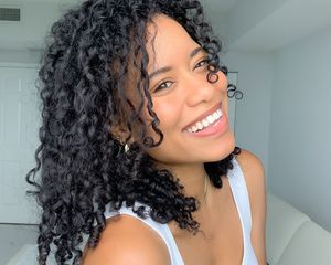 woman with curly hair smiling