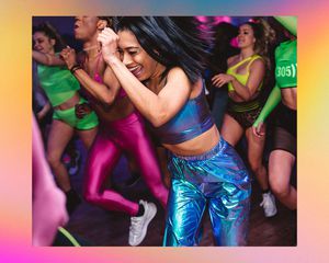People in vibrant clothes enjoy a fitness class