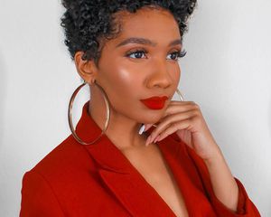 Black woman with short curly hair.