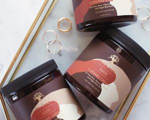 As I Am Curl Creams in a clear tray, with a marble background.