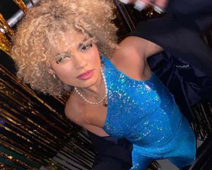 Model wearing blue glitter top and pants set.
