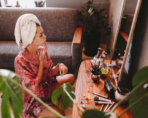 woman applying moisturizer