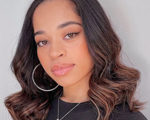 Ella Mai with a sew-in hairstyle.