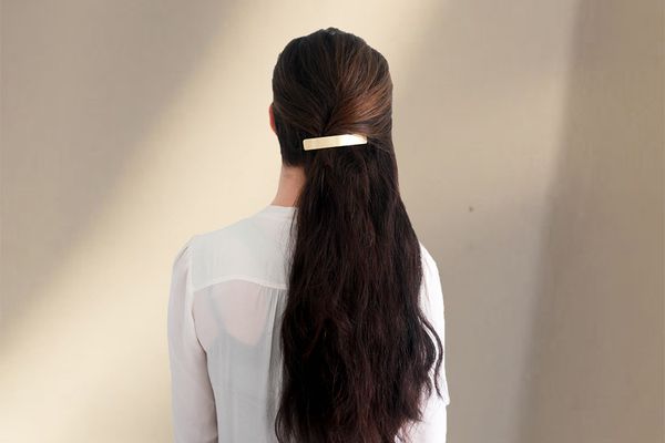 woman with long hair and gold clip 