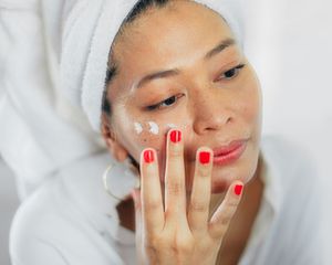 Woman applying face cream