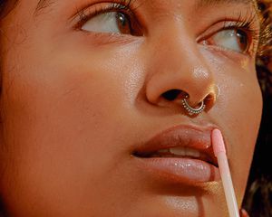 woman applying lip gloss