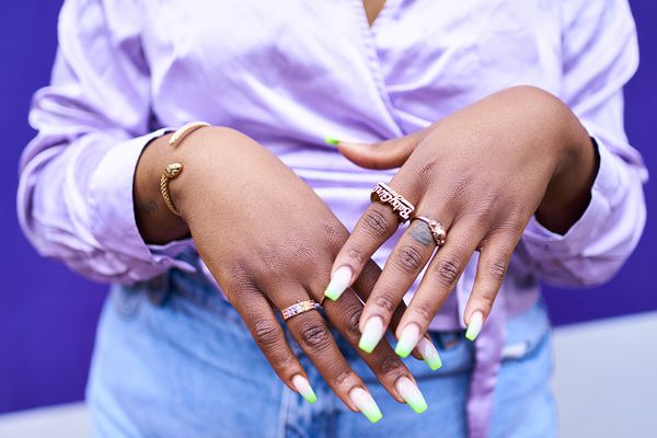 Close up of a woman's hands with acrylic nails.