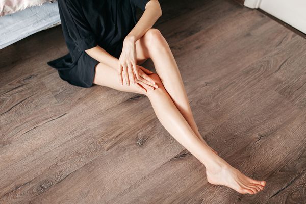 woman touching legs