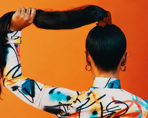 person holding hair in a ponytail