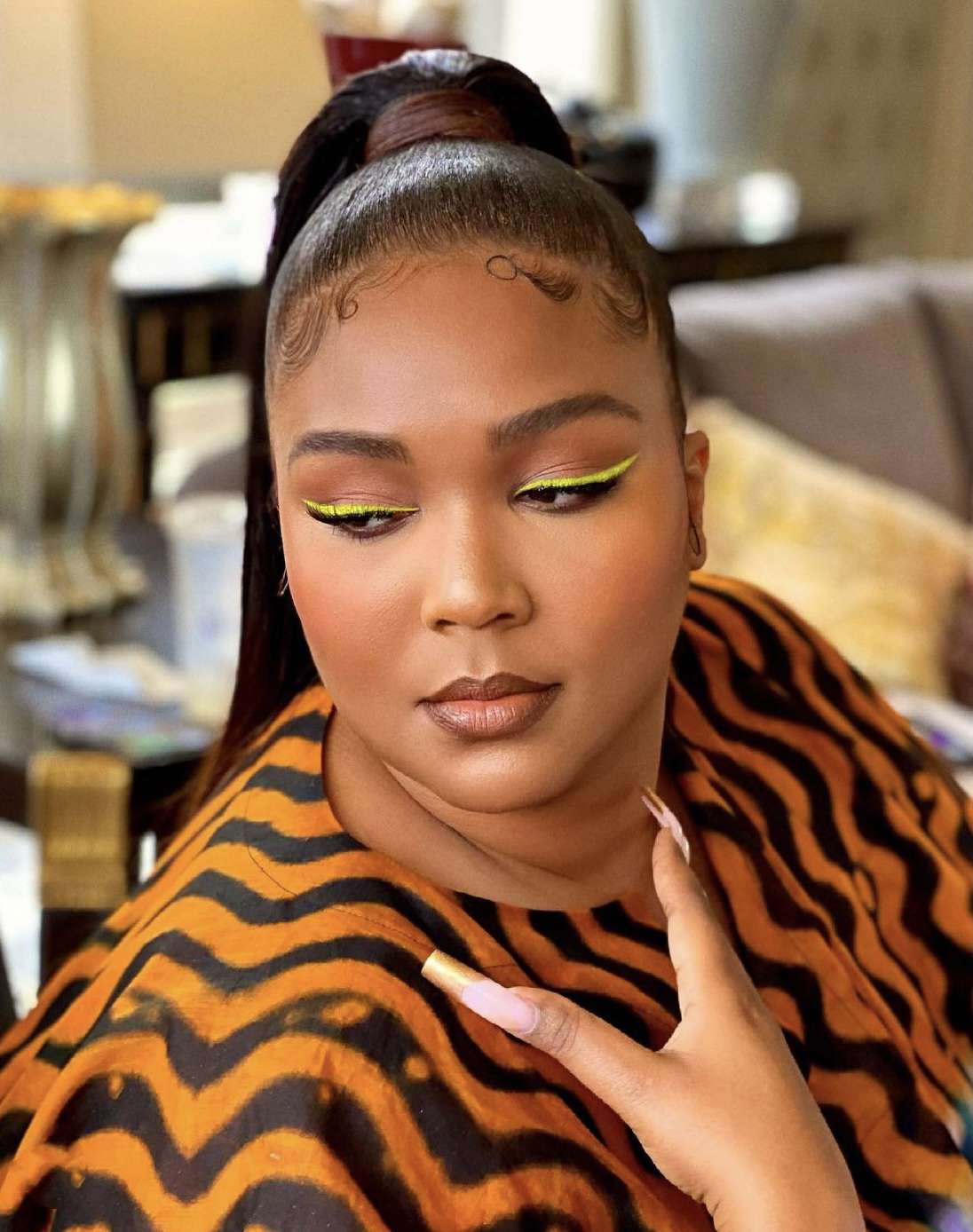 Lizzo wearing neon yellow liner