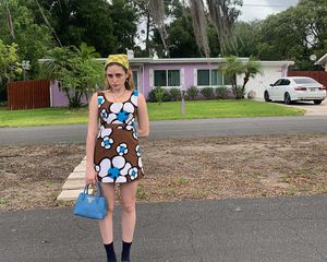 The author, Jo Rosenthal, wearing a blue mini skirt and black bikini top in Miami.