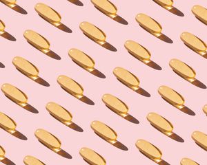 rows of pills on pink background