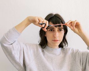 woman cutting bangs