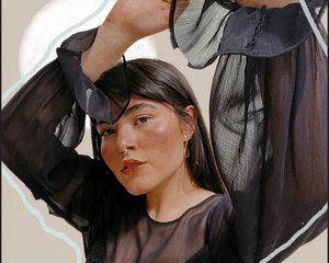 woman in black with hands in air