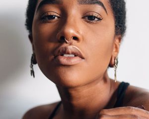 a woman with multiple facial piercings