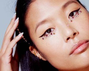 person with eyeliner and jewels