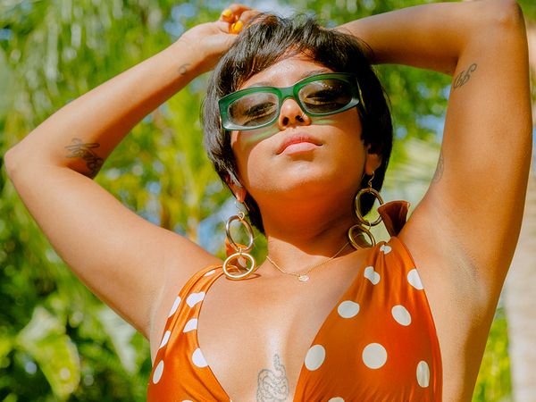 person in sun with tattoos