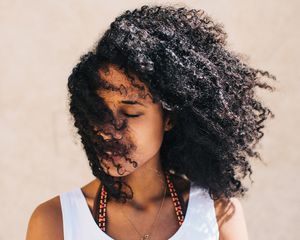 Young woman with dark curly hair