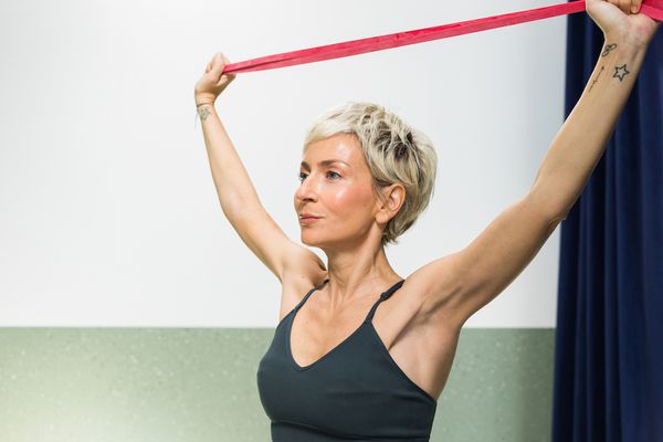 woman using arms resistance band 
