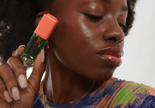 Model holding Youthforia BYO Blush Oil