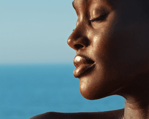 woman wearing gisou's honey-infused balm
