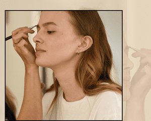 A Makeup Artist Applying Makeup to a Seated Woman