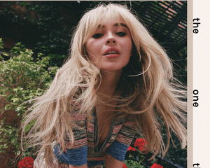 Sabrina Carpenter in striped top and blonde bangs