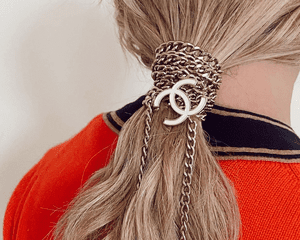 woman with chanel chains in ponytail