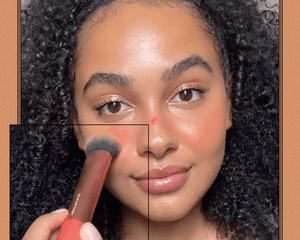 TikToker trying the faux sunburn blush trend