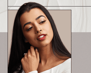 Indian Woman Smiling Looking Off to the Side on A Designed Background