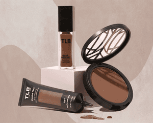 Makeup Products for Women of Color that are Black-Owned Styled Against a Neutral Abstracted Designed Background